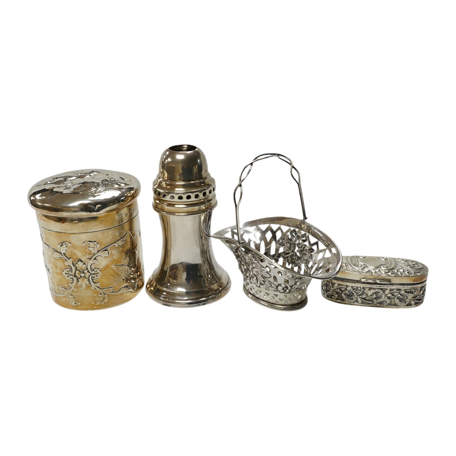 An Edwardian silver 'Reynold's Angels' silver canister, William Comyns, London, 1902, 90mm, together with a silver table perpetual lighter, silver bonbon basket and silver ring box. Condition - poor to fair